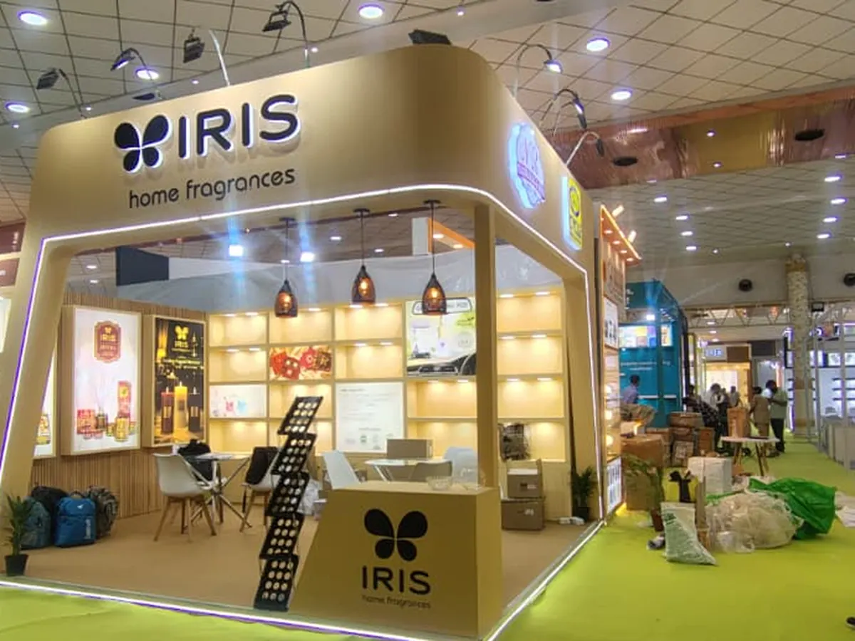 IRIS island booth with pendant lights and wooden display wall