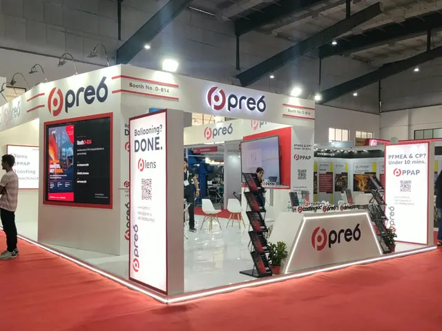 pre6 exhibition booth with backlit lightboxes, video wall and reception counter