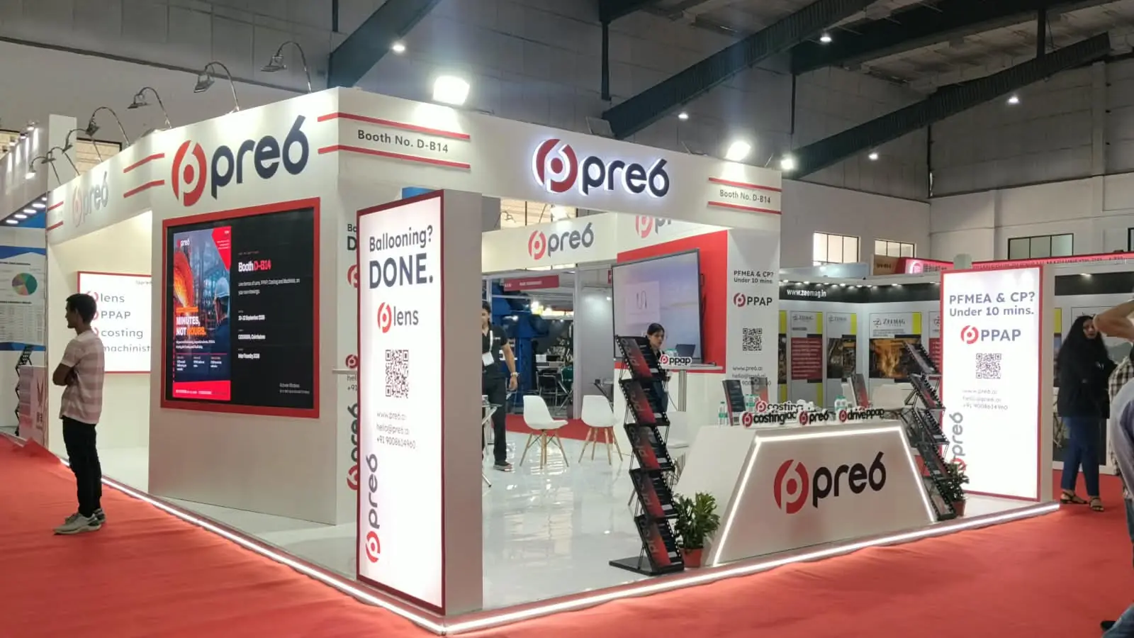 pre6 exhibition booth with backlit lightboxes, video wall and reception counter